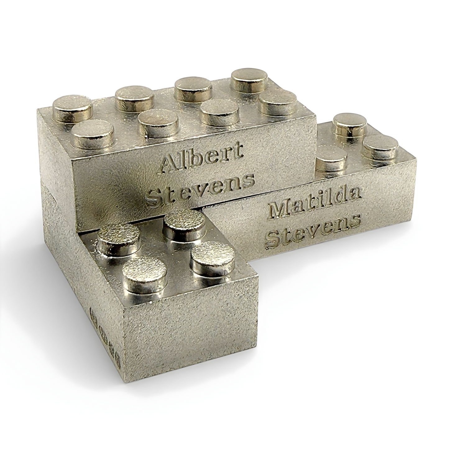 Metal blocks with engraved names on a white background